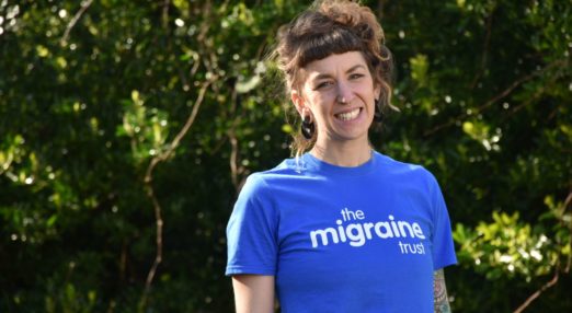Sophie, our fundraising officer, smiling in The Migraine Trust T-shirt