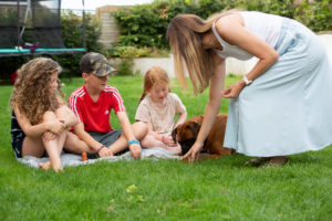 Niki and her three children, feeding their dog