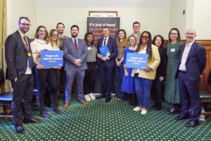 A group of MPs and patient advocates posing for a photo in the House of Commons