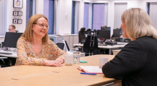 Two people having a discussion in the workplace