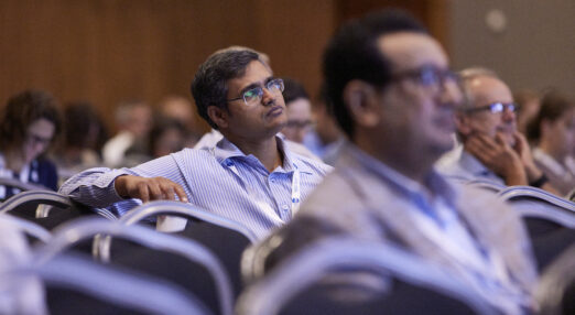 Two men sitting listening to a lecture