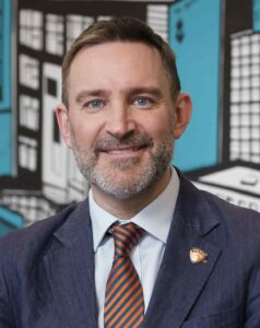 A man in a suit with a red tie