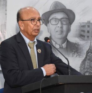  Dr Ahmed stands at a podium