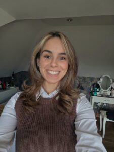 A woman with blonde hair smiles at the camera