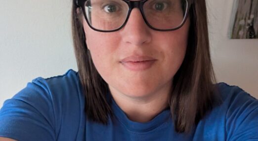 A woman is looking straight at the camera.