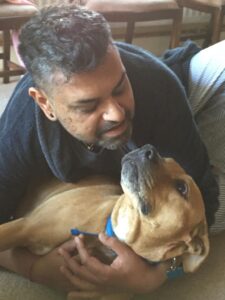A man looks down lovingly at his dog.